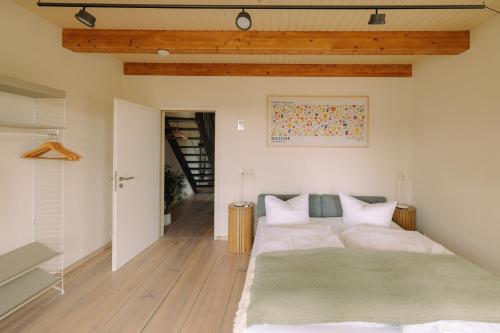 a bedroom with a large bed with a green rug at Eldehaus Plau am See klimatisiert in Plau am See