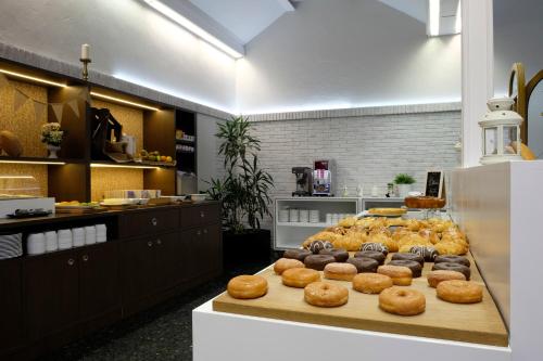 a bakery with a bunch of donuts on a table at Spirit Hotel Ciudad de Burgos in Rubena