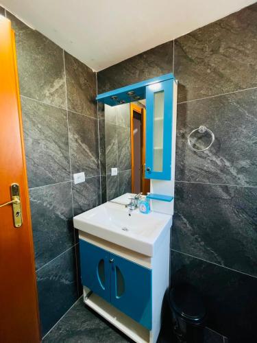 a bathroom with a sink and a mirror at Vila Francesko in Ksamil