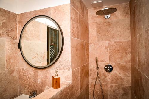 a bathroom with a sink and a mirror at Les Gens Heureux Appartement GLAZ in Paimpol
