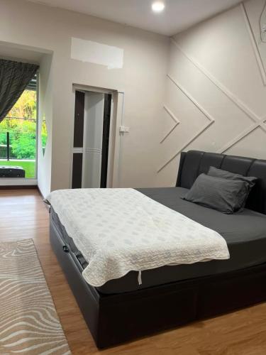 a bedroom with a bed with a black bed frame at Suzys homestay in Kuantan