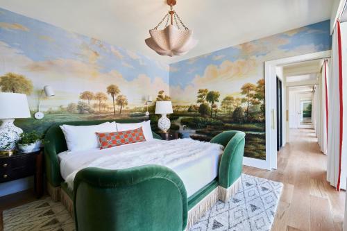 a bedroom with a painting on the wall at Virgin Hotels New Orleans in New Orleans