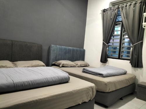a room with two beds and a window at 910 Entire Homestay Seremban Town, Templer, Lobak, Lekas Highway in Seremban