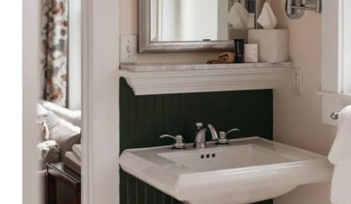 a bathroom with a white sink and a mirror at Mountain View Grand Resort & Spa in Whitefield