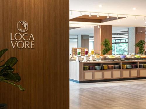 a restaurant with a laocoge sign on a wall at Mercure Miyagi Zao Resort & Spa in Zao