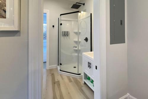 a bathroom with a shower with a glass door at The Hideaway on Tacketts - Shipping Container in Hurricane