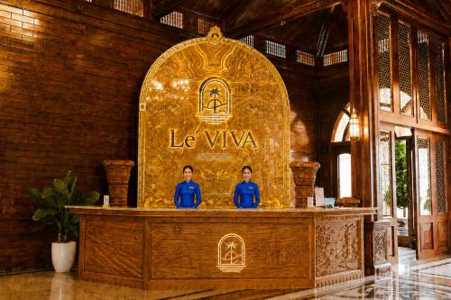 two people sitting at a altar in a building at Le' VIVA Resort Mui Ne in Mui Ne