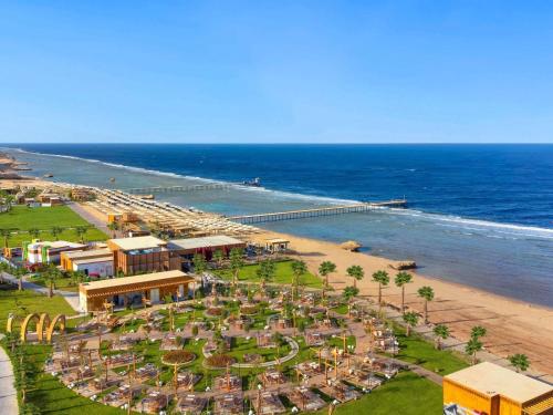 an aerial view of a beach with a resort at Rixos Radamis Sharm El Sheikh in Sharm El Sheikh