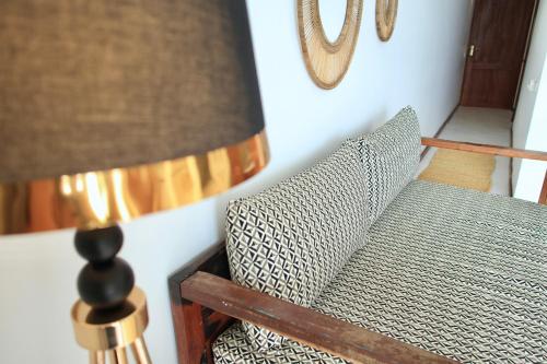 a living room with a couch and a lamp at ZAN Island Beach in Jambiani