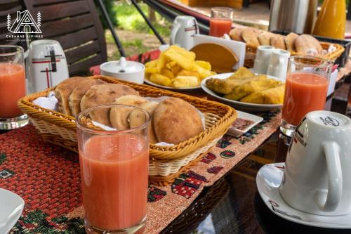 a table topped with baskets of food and drinks at Cabañas Alpinas en Oxapampa in Oxapampa