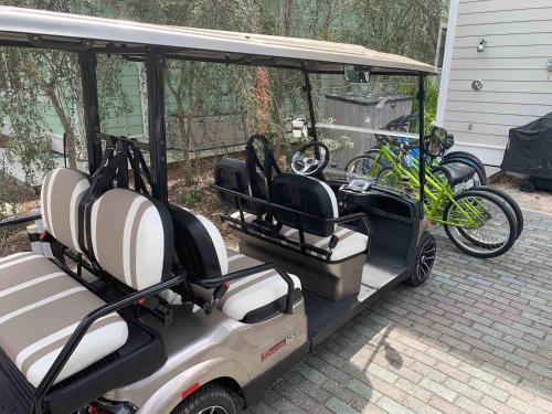a golf cart with a bike parked in it at Watercolor Whimsea in Seagrove Beach