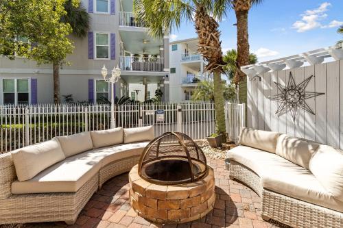 a patio with couches and a fire pit in front of a building at Easy Breezy in Santa Rosa Beach