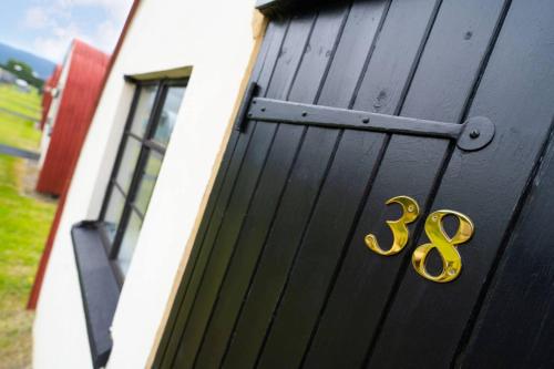 a black door with the number on it at Cultybraggan Hut 38 - Accessible in Comrie