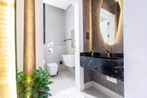 a bathroom with a black sink and a mirror at Amber Hospitality - Blvd in Riyadh