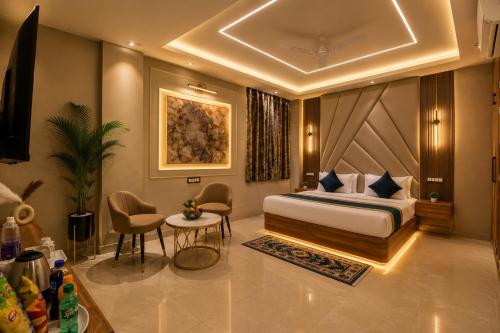a hotel room with a bed and a table and chairs at Hotel Smart International in New Delhi