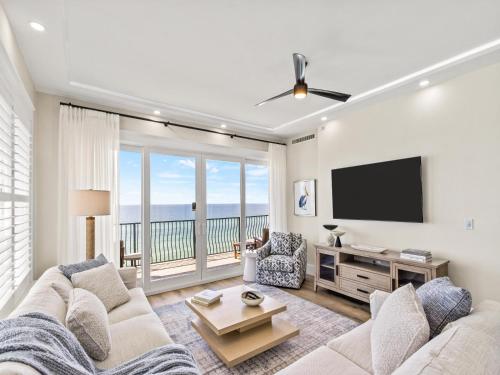 a living room with a couch and a flat screen tv at Adagio #401B in Santa Rosa Beach