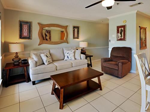 a living room with a couch and a chair at Grand Caribbean Perdido Key #114 West in Perdido Key