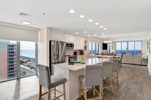 a kitchen and living room with a view of the ocean at Emerald Dolphin #1610 in Pensacola Beach