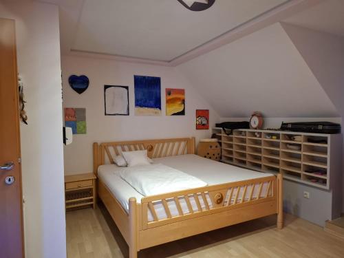 a bedroom with a bed and a book shelf at Villa Shakira in Zissersdorf