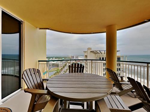 a table and chairs on a balcony with the ocean at Beach Colony East #15A in Perdido Key