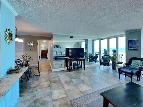a large living room with a flat screen tv at Sabine Yacht & Racquet #5F in Pensacola Beach
