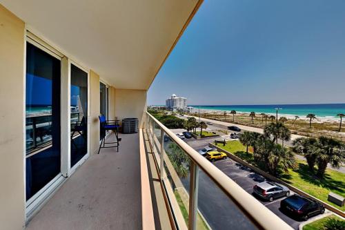 a balcony with a view of the beach and the ocean at Sabine Yacht & Racquet #5F in Pensacola Beach