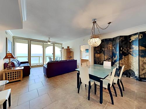 a dining room and living room with a table and chairs at Portofino Island Resort #2-1608 in Pensacola Beach