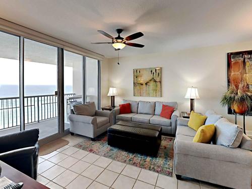 a living room with a couch and a ceiling fan at Emerald Dolphin #1630 in Pensacola Beach