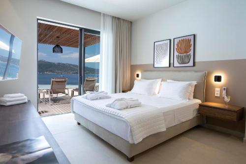 a bedroom with a bed with a view of the ocean at Zoe Sea View Villas in Paleros