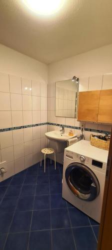a bathroom with a washing machine and a sink at Haus Rüther in Borkum