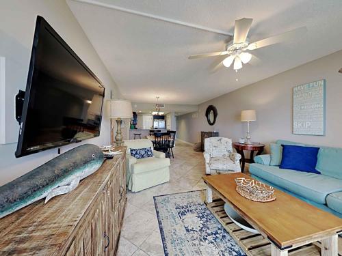 a living room with a large flat screen tv at Regency Towers #205 West in Pensacola Beach