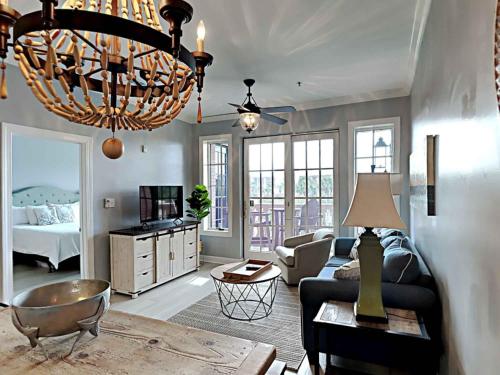 a living room with a couch and a chandelier at Village Of South Walton #263A in Rosemary Beach