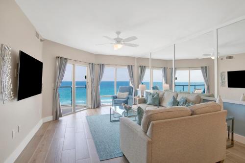 a living room with a couch and views of the ocean at Emerald Isle #602 in Pensacola Beach