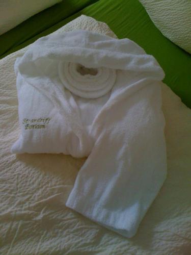 a white towel sitting on top of a bed at Strandriff in Borkum