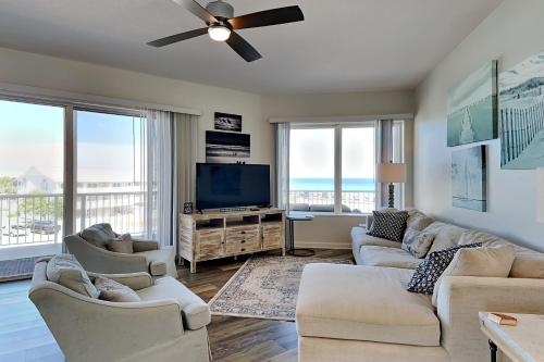 a living room with couches and a flat screen tv at Crystal View #303 in Destin