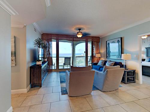 a living room with a couch and chairs and a table at Portofino Island Resort #1-702 in Pensacola Beach
