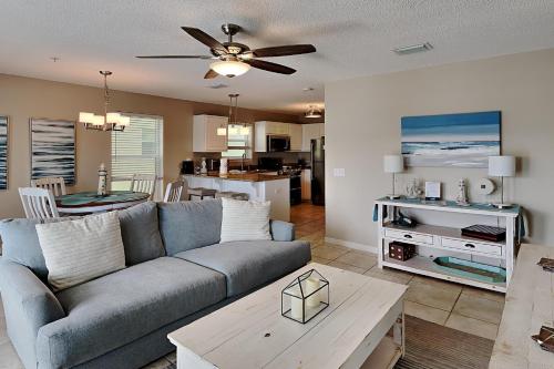 a living room and kitchen with a couch and a table at Gulf Island #621 in Navarre