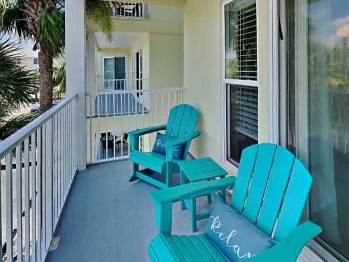 two blue chairs sitting on a porch at Gulf Island #621 in Navarre