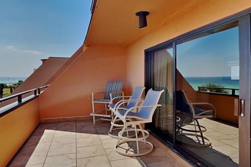 a balcony with chairs and a view of the ocean at Aegean #332 in Destin