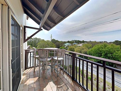a balcony with a table and chairs on it at Eastern Lake Village #E - Just 4 Fun in Seagrove Beach