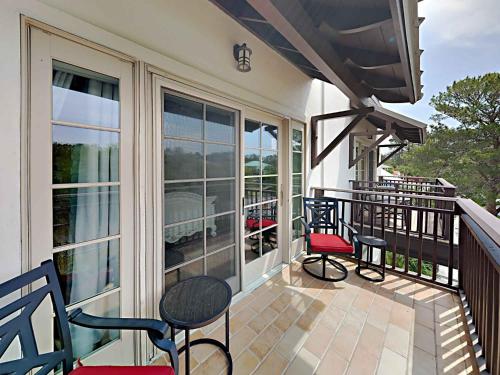 a screened porch with chairs and tables on a balcony at Eastern Lake Village #E - Just 4 Fun in Seagrove Beach
