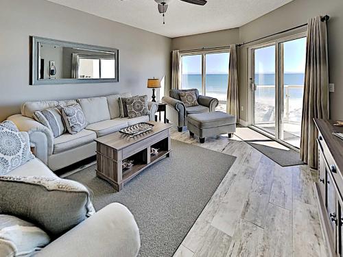 a living room with a couch and a table at Emerald Isle #405 in Pensacola Beach