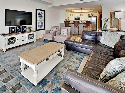 a living room with a couch and a table at Phoenix West II #2109 in Orange Beach