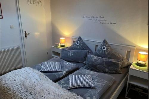 a bedroom with two beds with blue pillows at Ferienwohnung 1 Gemutlich & komfortabel im Erdgeschoss in Borkum