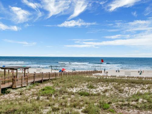 a beach with a wooden boardwalk and the ocean at Beach Colony Towers #2B - Villa Monarch in Perdido Key