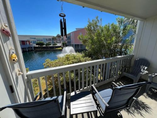 a porch with two chairs and a view of a pond at Villas on the Gulf #E7 - Flip Flop Inn in Pensacola Beach