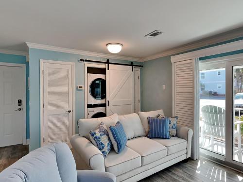 a living room with a white couch and blue walls at Beachside Villas 911 in Seagrove Beach