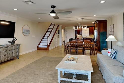 a living room with a couch and a table at Aegean #332 in Destin