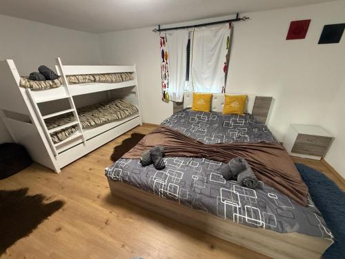 a bedroom with a bed and a bunk bed at Villa ADUSHI Nashec in Prizren