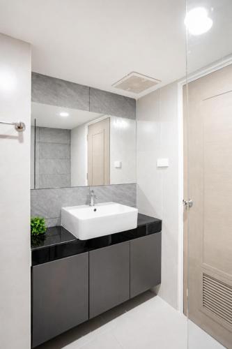 a bathroom with a sink and a mirror at Sweet room in Nimnan in Chiang Mai